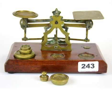 A mahogany and brass post office scale and weights.