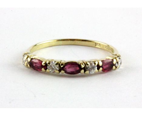 A 9ct yellow gold half eternity ring set with marquise cut rubies and white stones, (O).