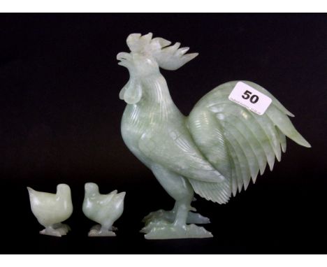 A Chinese carved jade/ hardstone figure of a cockerel, H. 20cm together with two chicks.