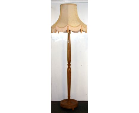 A satinwood standard lamp and shade.