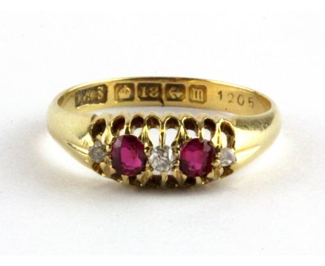 An 18ct yellow gold ring set with oval cut rubies and diamonds, (K.5).
