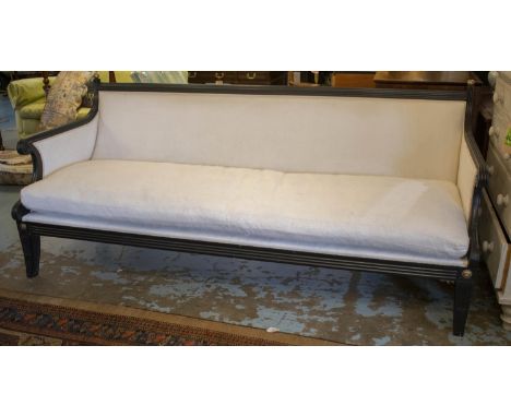 SOFA, Regency style, ebonised in white fabric with squab cushion, 223cm W. (cushion requires cover) 