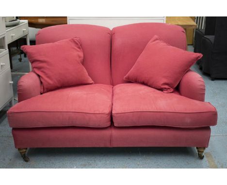 HOWARD STYLE SOFA, dusky pink covers with seat and scatter cushions on beech feet and brass castors, 135cm x 110cm. (slight f