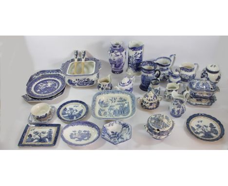 A collection of blue and white oriental pottery pieces to include willow pattern water jugs, Hanley tureens, Crown pottery bo