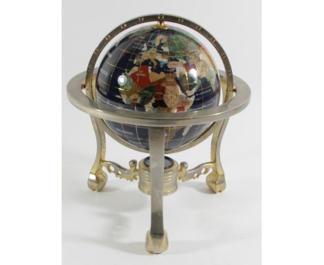 A semi precious gemstone world globe with compass, rotating in its axis on a cast brass stand. 