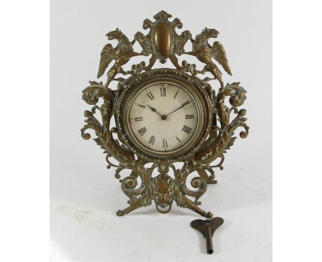A Victorian cast brass easel mantle clock, the frame with Griffins either side of a shield, floral scrolls and lion mask, Fre