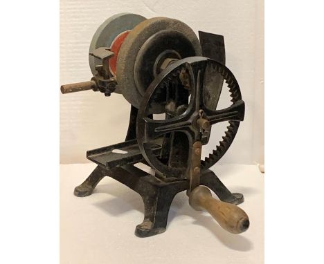 A cast iron manual grinder, two grinding wheels, adjustable tool rail, wooden handle, 32cm tall, together with a cast iron pi