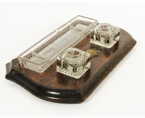 A Victorian desk inkwell stand, comprising of twin glass inkwells, glass pen try on a mahogany stand with attached garter bad