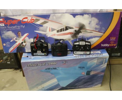 Boxed Super Cub Hobby Zone r/c plane, a boxed FlyFly Mirage 2000 and a boxed Twister r/c Hawk