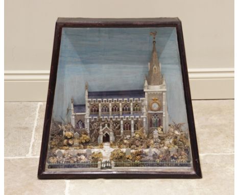 A late 19th/early 20th century cased church diorama, reputedly a South Wales church, the spired church with Gothic style wind