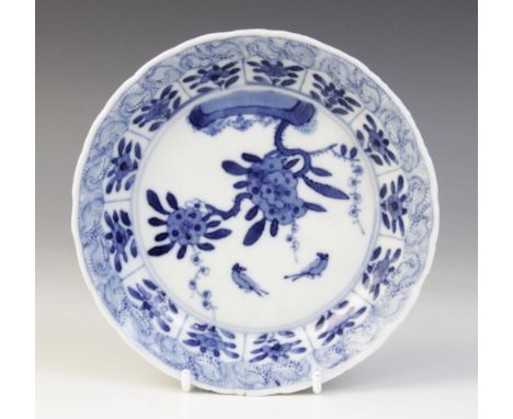 A Chinese porcelain blue and white saucer, 18th century, of circular form centrally decorated with blossoming branches and bi