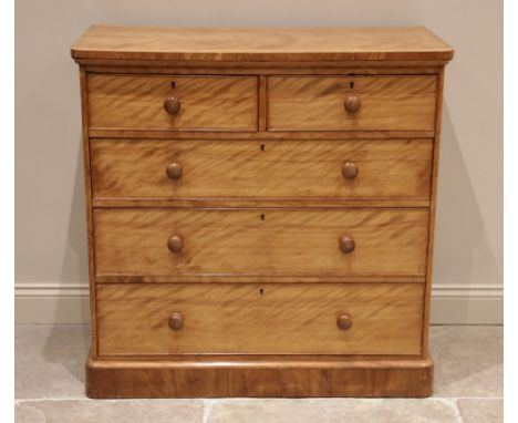 A Victorian satin birch chest of drawers, finished with a tiger stripe patina, the rectangular top with rounded front corners