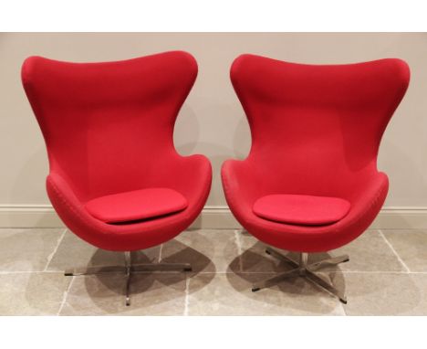 A pair of 1960's egg shaped revolving office chairs in the style of Arne Jacobsen for Fritz Hansen, each covered in vibrant r