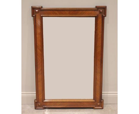 A French kingwood wall mirror, early 20th century, the pronounced angular corners centred with moulded rivet detail, enclosin