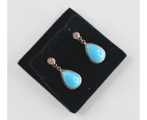 A pair of diamond and turquoise coloured drop earrings, each designed as a round brilliant cut diamond weighing approximately