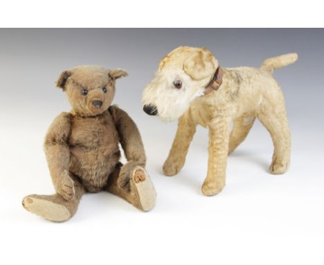 A Steiff type mohair wood wool filled teddy bear of small proportions, early 20th century, the body with disk jointed limbs, 