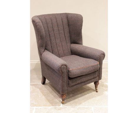 A 'Harris Tweed' wing back fireside armchair, late 20th century, the scalloped padded back rest enclosed by shaped wing backs