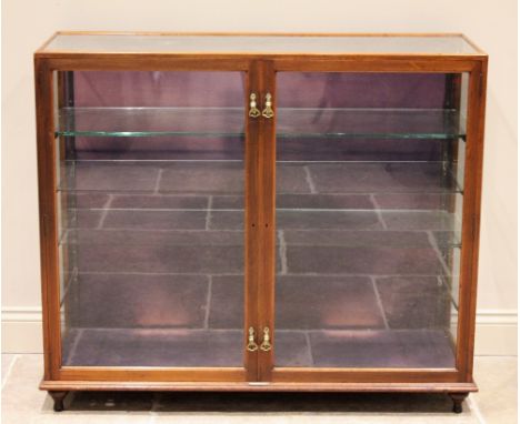 A late 19th/early 20th century mahogany shop/retail display cabinet, by Sage & Co, London, the two glazed doors applied with 