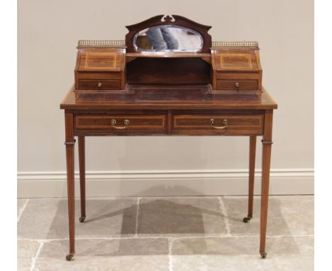 An Edwardian mahogany and satinwood cross banded bonheur de jour, in the manner of Edwards &amp; Roberts, the raised back cen
