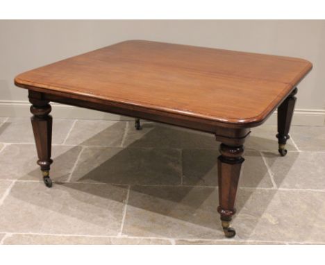 A Victorian mahogany extending dining table, the rectangular top with rounded corners and a moulded edge, raised upon taperin