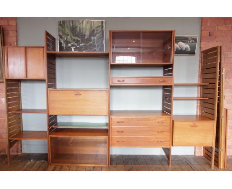 A 1960's/70's Staples teak Ladderax wall unit, comprising; seven ladder racks, two glazed cabinets, one single drawer chest, 