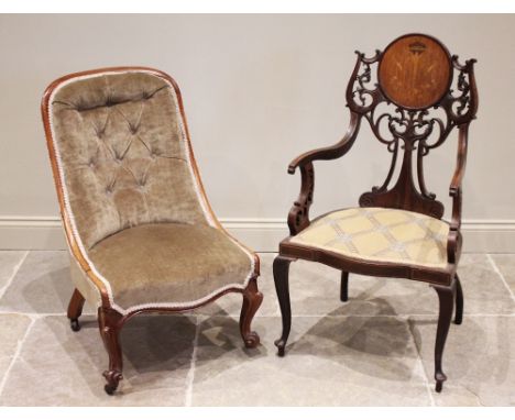 An Edwardian mahogany elbow chair, the 'C' scroll openwork back united by a circular panel inlaid with foliate swag detail, e