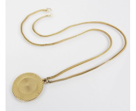 A 9ct gold medallion pendant, of circular form with vacant central cartouche and engine turned border, 21mm diameter, upon a 