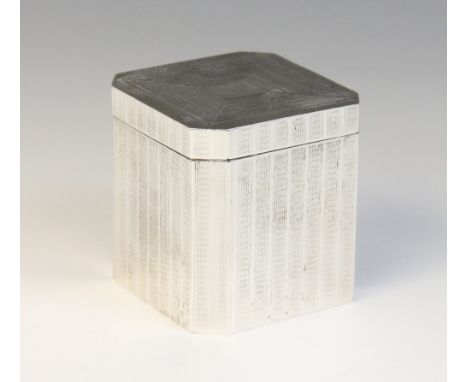 An Art Deco tea caddy, of faceted form with engine turned decoration, opening to reveal integral caddy spoon to cover, marked