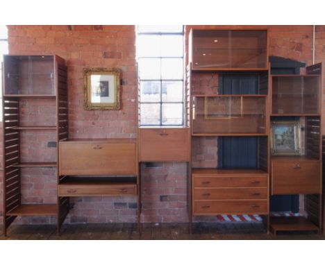 A 1960's/70's Staples teak Ladderax wall unit, comprising; seven ladder racks, four glazed cabinets, one single drawer chest,