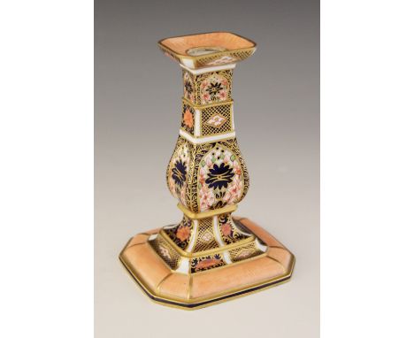 A Royal Crown Derby imari candlestick in the 1128 pattern, early 20th century, of rectangular baluster form on stepped spread