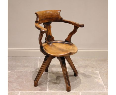 A late Victorian oak and pollard oak Aesthetic Movement revolving office desk chair, the pollard oak horse shoe top rail with