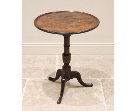 A George III mahogany tray top tripod table, the circular tilt top with raised moulded rim, upon a ring turned and cup pedest