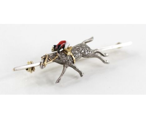 RACING INTEREST: A diamond and enamel bar brooch, modelled as a horse and jockey, the horse's body set with single cut diamon