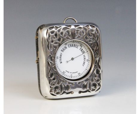 An Edwardian silver mounted pocket watch stand, William Comyns, London 1903, of rectangular form with pierced foliate silver 