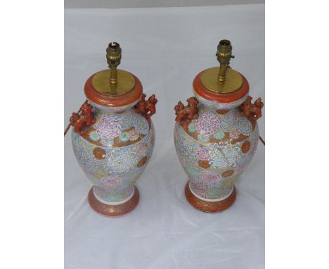 Pair of Chinese ceramic lamp bases, flanked with dogs of fo, H.37cm