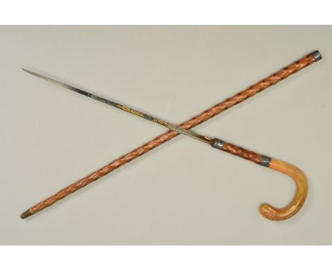 A LATE VICTORIAN SWORD STICK, curved horn handle with plated mounts, the etched blade named 'TOLEDO', blade length 36cm, in a