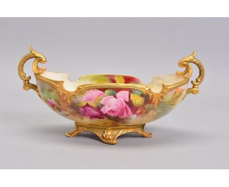 A ROYAL WORCESTER TWIN HANDLED BOAT SHAPED PEDESTAL BOWL, painted with pink roses, signed by Jack Southall, green and gilt ri