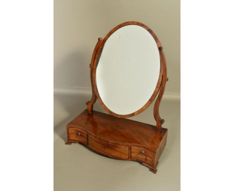 A GEORGE III MAHOGANY TOILET MIRROR, with satinwood and ebony banding, oval mirror on scrolled arms with a serpentine base fi