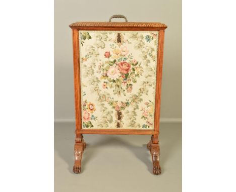 A LATE VICTORIAN WALNUT FIRE SCREEN, of rectangular form, fitted with a central gilt metal handle with pull up screen, moulde