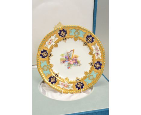 A STEFAN NOWACKI PORCELAIN CABINET PLATE, of silver shape with gadrooned rim, raised gilding to the border interspersed with 