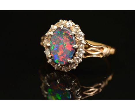 A GOLD EARLY 20TH CENTURY FINE BLACK OPAL AND DIAMOND RING, centring on an oval black oval, measuring 11mm x 8.0mm, good play