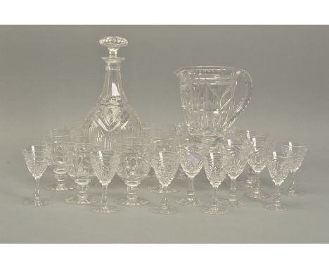 JOHN WALSH WALSH, a 1920's part table suite comprising a water jug, decanter, six red, six white and six port glasses, all cu