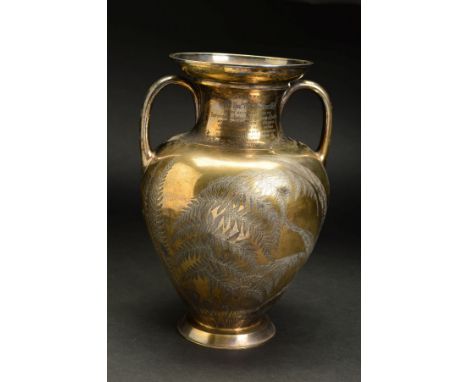 A VICTORIAN SILVER GILT TWIN HANDLED VASE, of baluster form and engraved with ferns, bearing a presentation inscription 'Pres