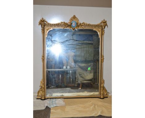 A MID 19TH CENTURY GILTWOOD OVERMANTEL MIRROR, of rectangular form, the pediment with swag and urn finials flanking an oval f