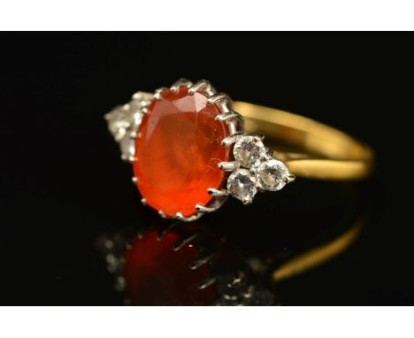 A LATE 20TH CENTURY FIRE OPAL DRESS RING, centring on an oval mixed cut fire opal, measuring approximately 11.0mm x 8.7mm, fl