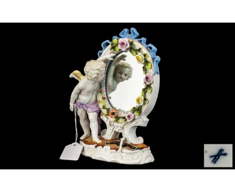 German Decorated Porcelain Mirror, with Cupid with bow and arrow and the mirror adorned with porcelain flowers.  Measures 9" 