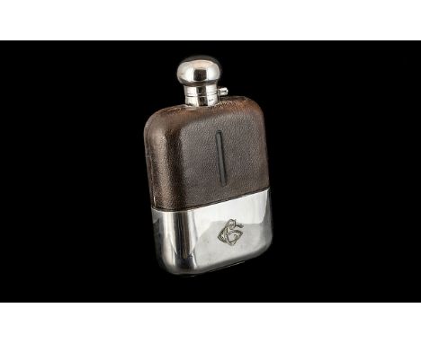 A Jumbo Size Gentleman's Silver Plated Hip Flask, with a leather clad body, maker's name to top J D &amp; Sons. Cracked to gl