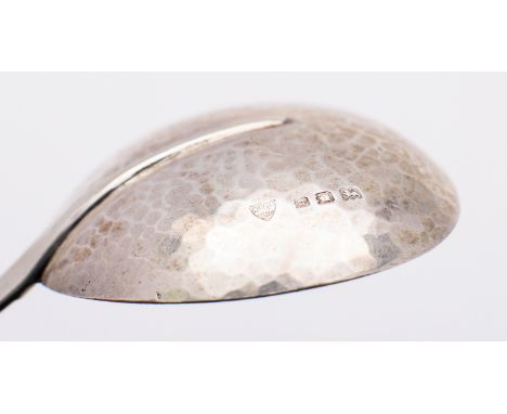 An Arts & Crafts silver caddy spoon by The Artificers' Guild, London 1923, the hammered pear shaped bowl with tapering stem, 
