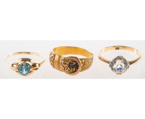 A group of three rings, including a 9ct gold Victorian buckle ring with floral and foliate carving all the way around the ban