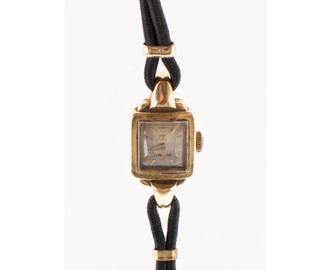 Omega a lady's 18K wristwatch the square silvered dial having round gold plated baton numerals, gold Dauphine hands and signe